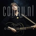 09-02-1978 Nick Lowe at studio in Amsterdam.

[keywords]Posed, Half Length, Eyecontact, Guitar, Smoking[/keywords]